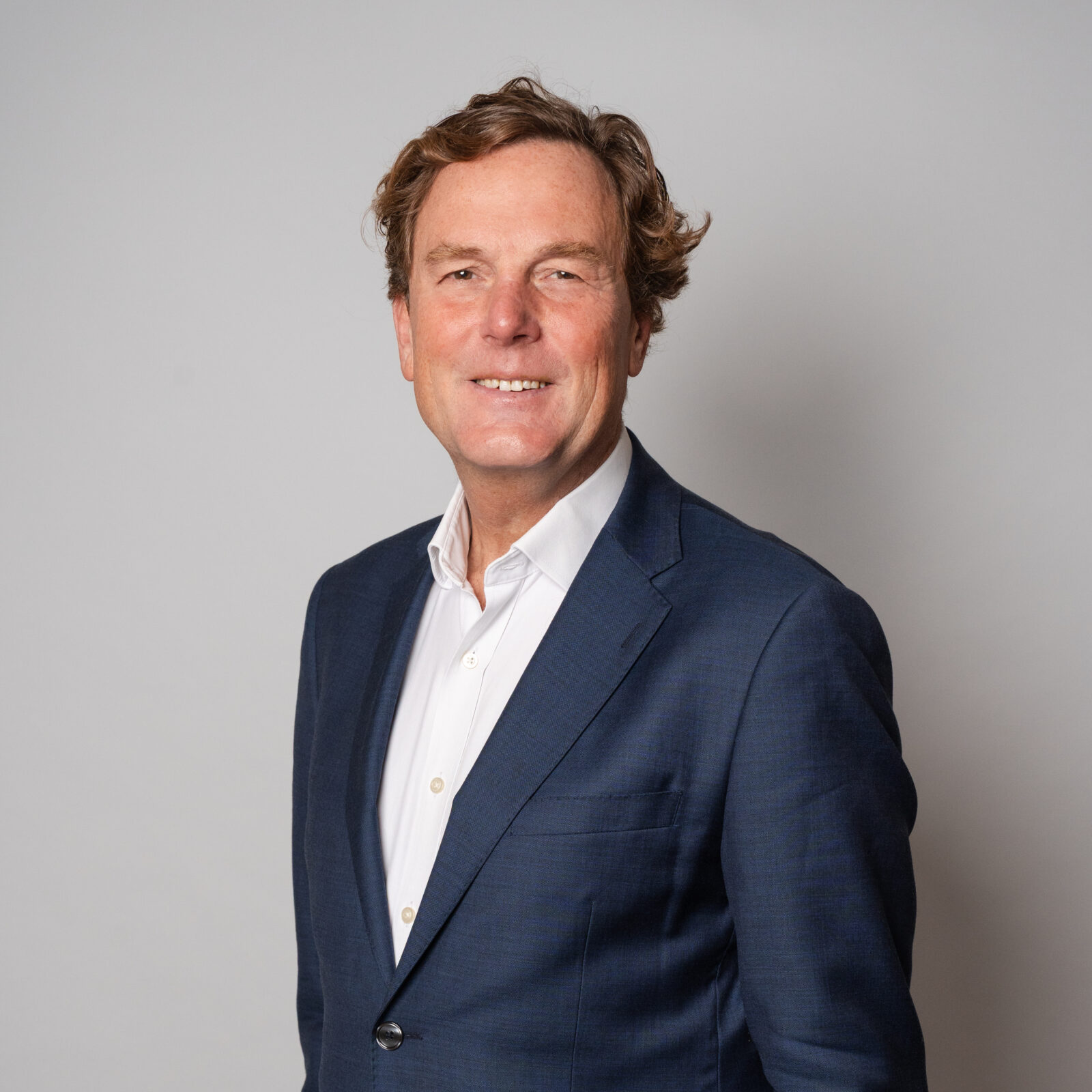 Professional portrait of CEO Arjan Bol wearing a jacket and shirt against a neutral background